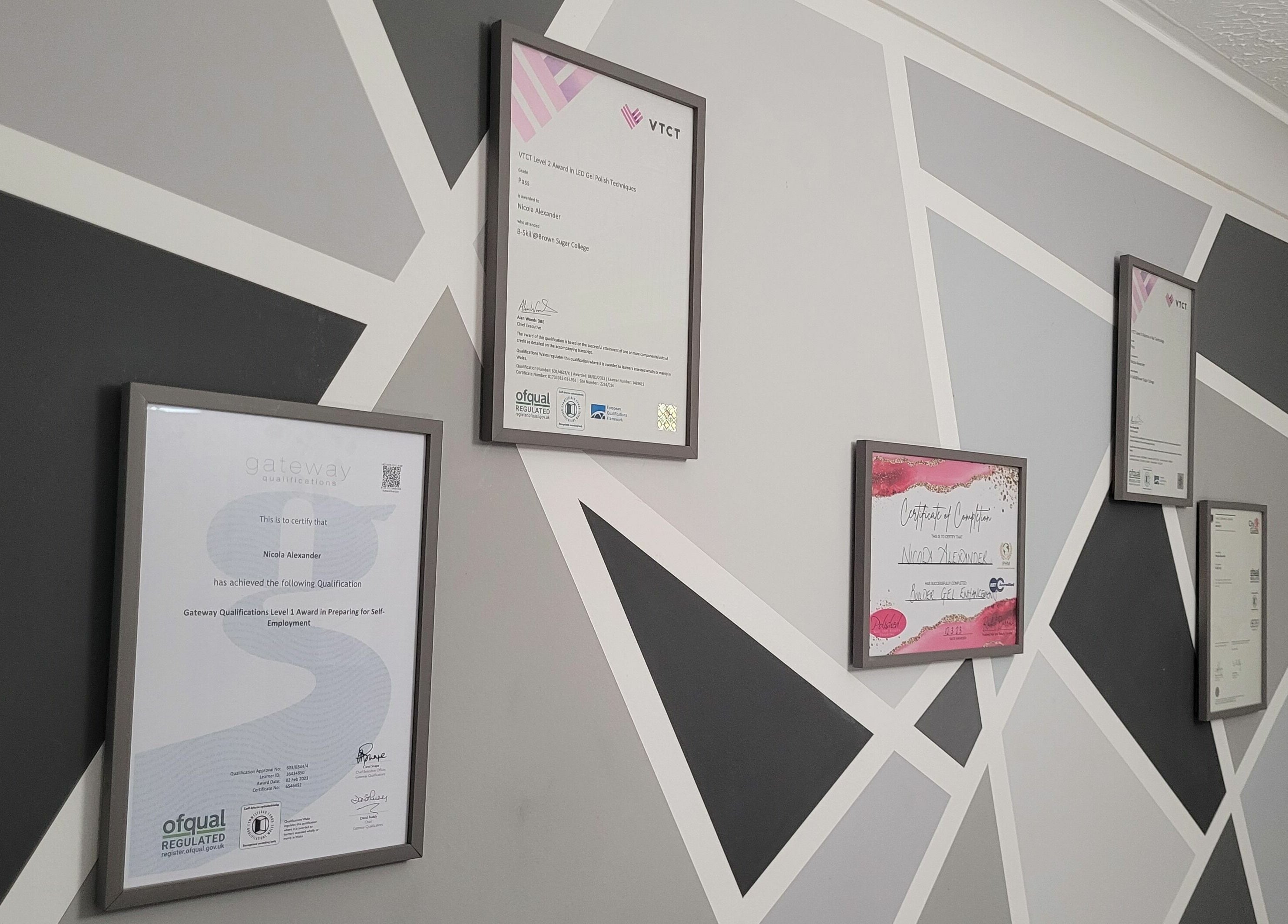 Display of framed certifications at Nails at No. 9, Brough, England, GB, showcasing expertise and quality.