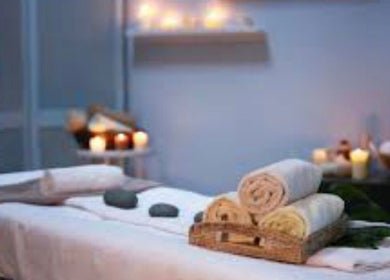 Relaxing spa setting at Brow Expert Beauty in Dublin, County Dublin, IE, with candles and towels.
