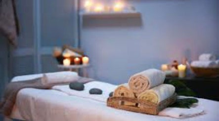 Relaxing spa setting at Brow Expert Beauty in Dublin, County Dublin, IE, with candles and towels.