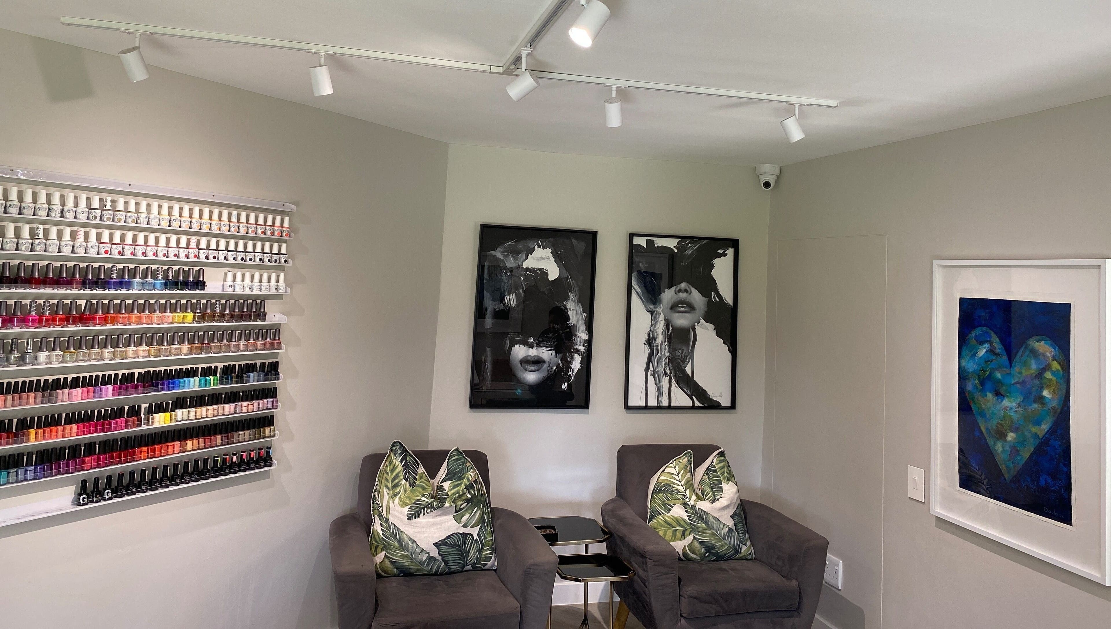 Nail polish display and cozy seating at DASH, Johannesburg, Gauteng, ZA. Elegant salon decor with vibrant colors.