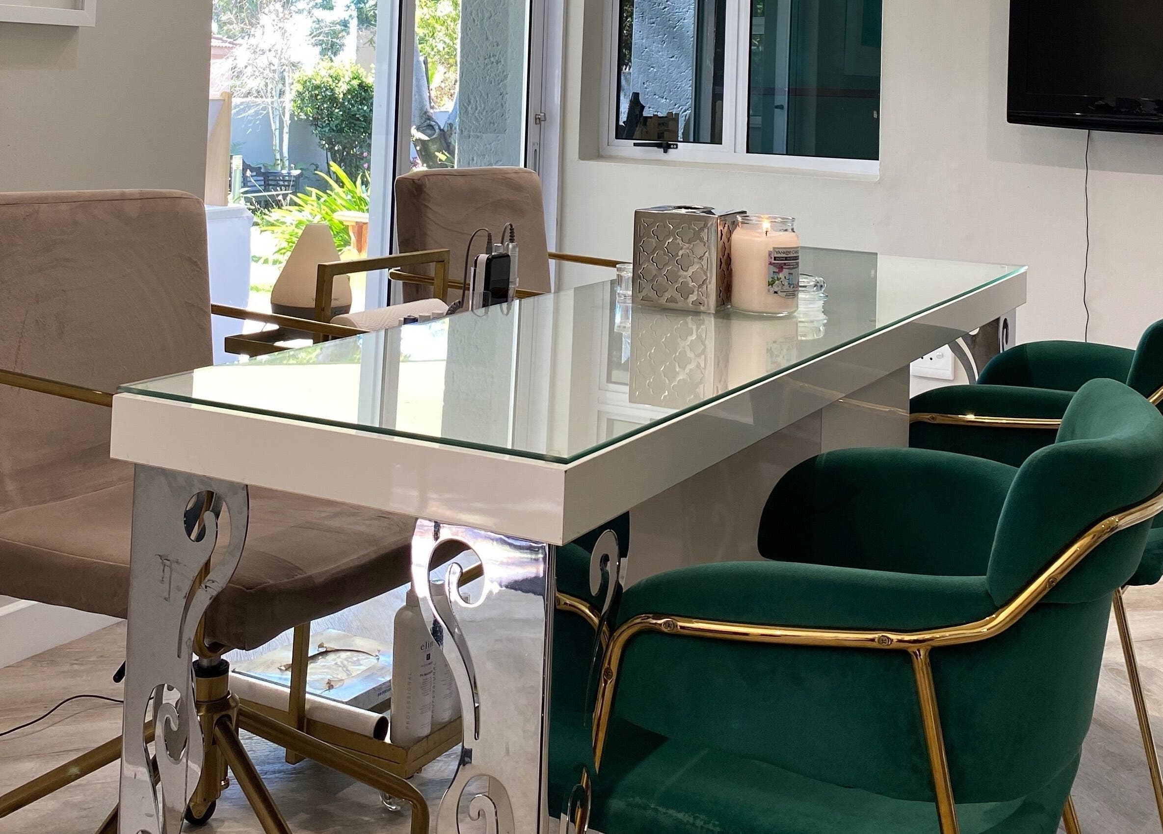 Stylish seating at DASH, Johannesburg, Gauteng, ZA, featuring plush green chairs and a glass table.