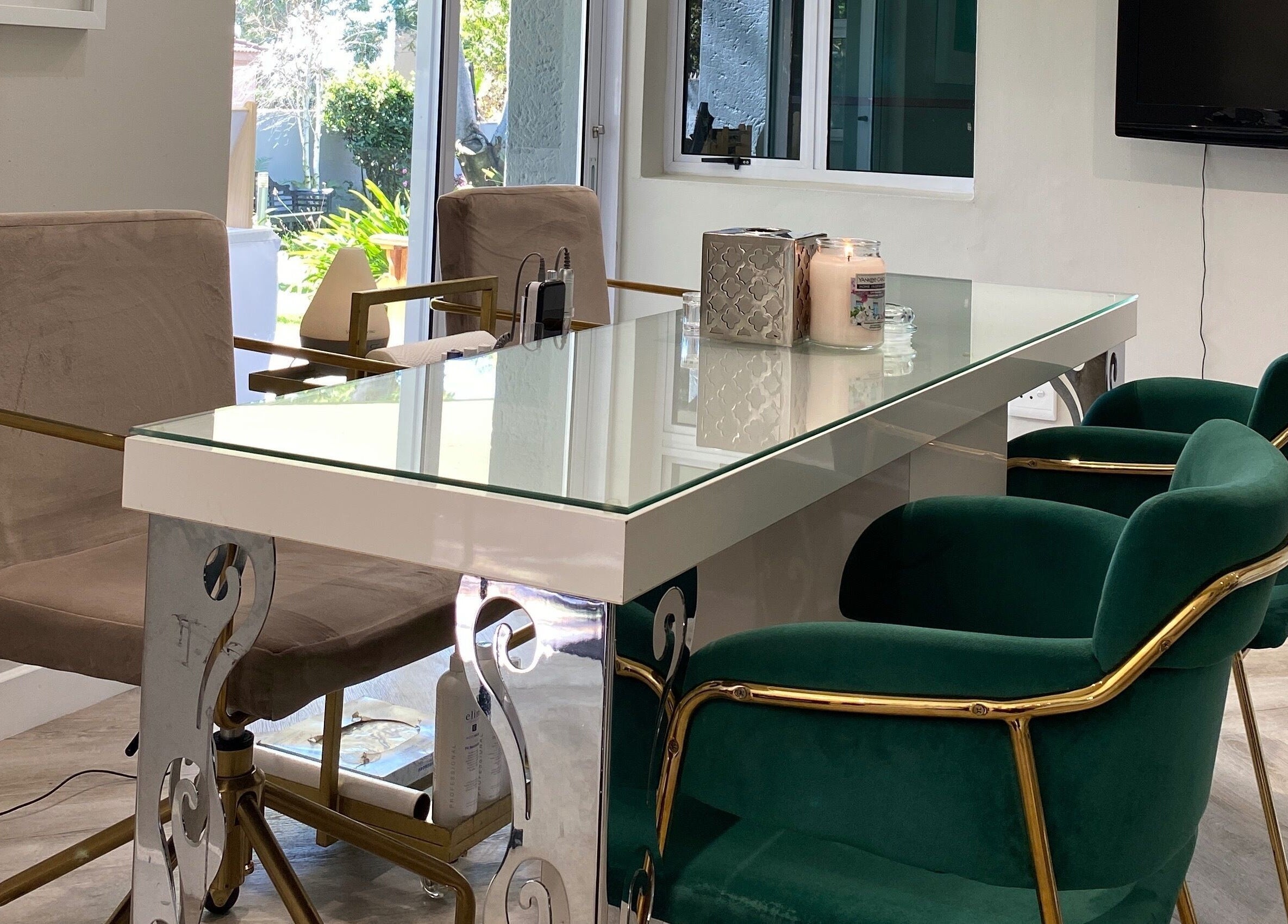 Stylish seating at DASH, Johannesburg, Gauteng, ZA, featuring plush green chairs and a glass table.