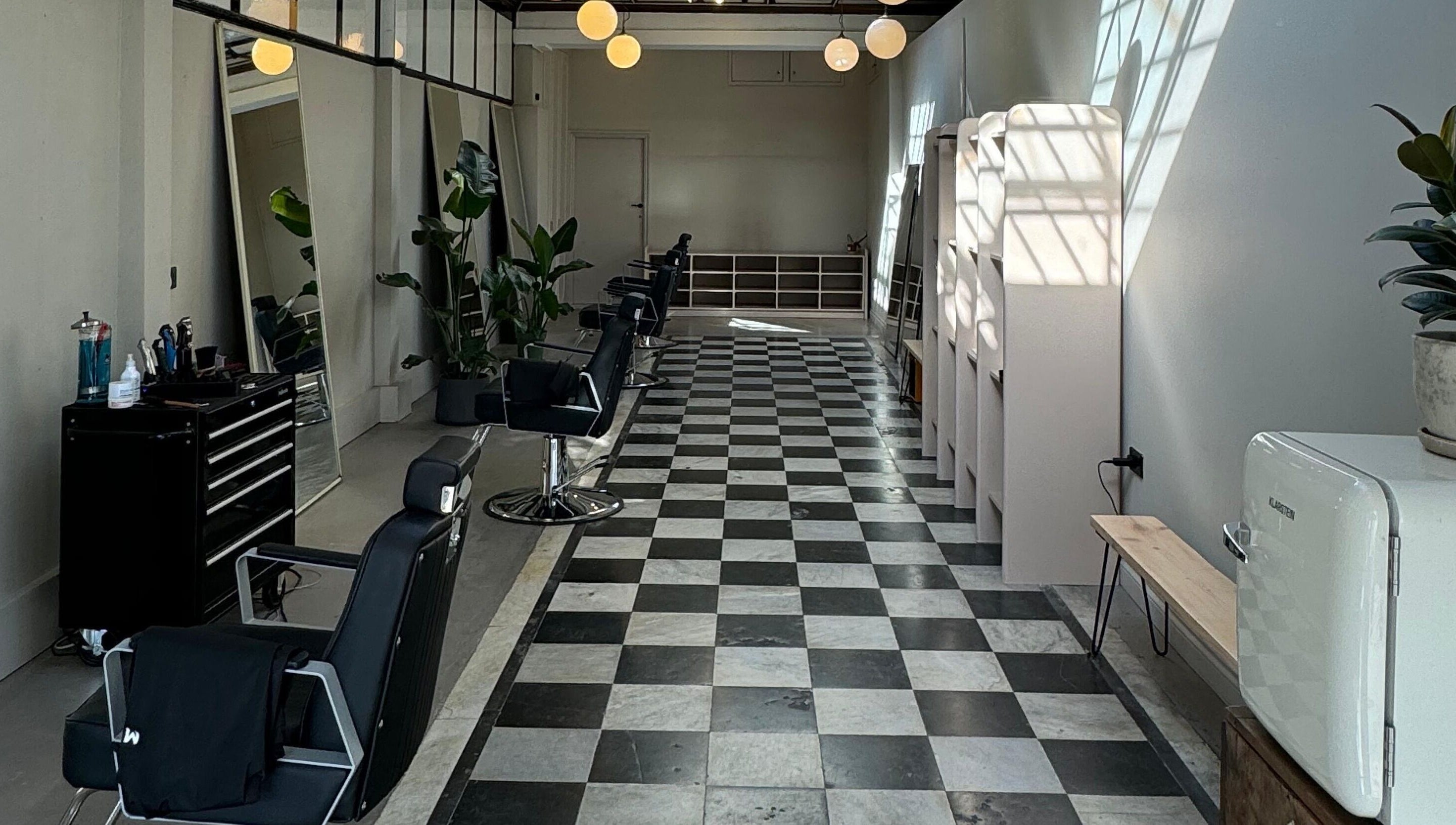 Interior of MOAI Barber Studio in London, England, GB, features sleek chairs and modern decor.