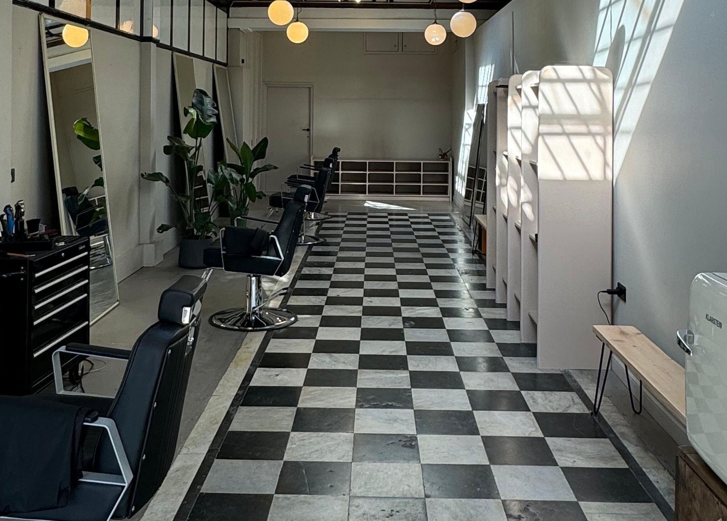 Interior of MOAI Barber Studio in London, England, GB, features sleek chairs and modern decor.