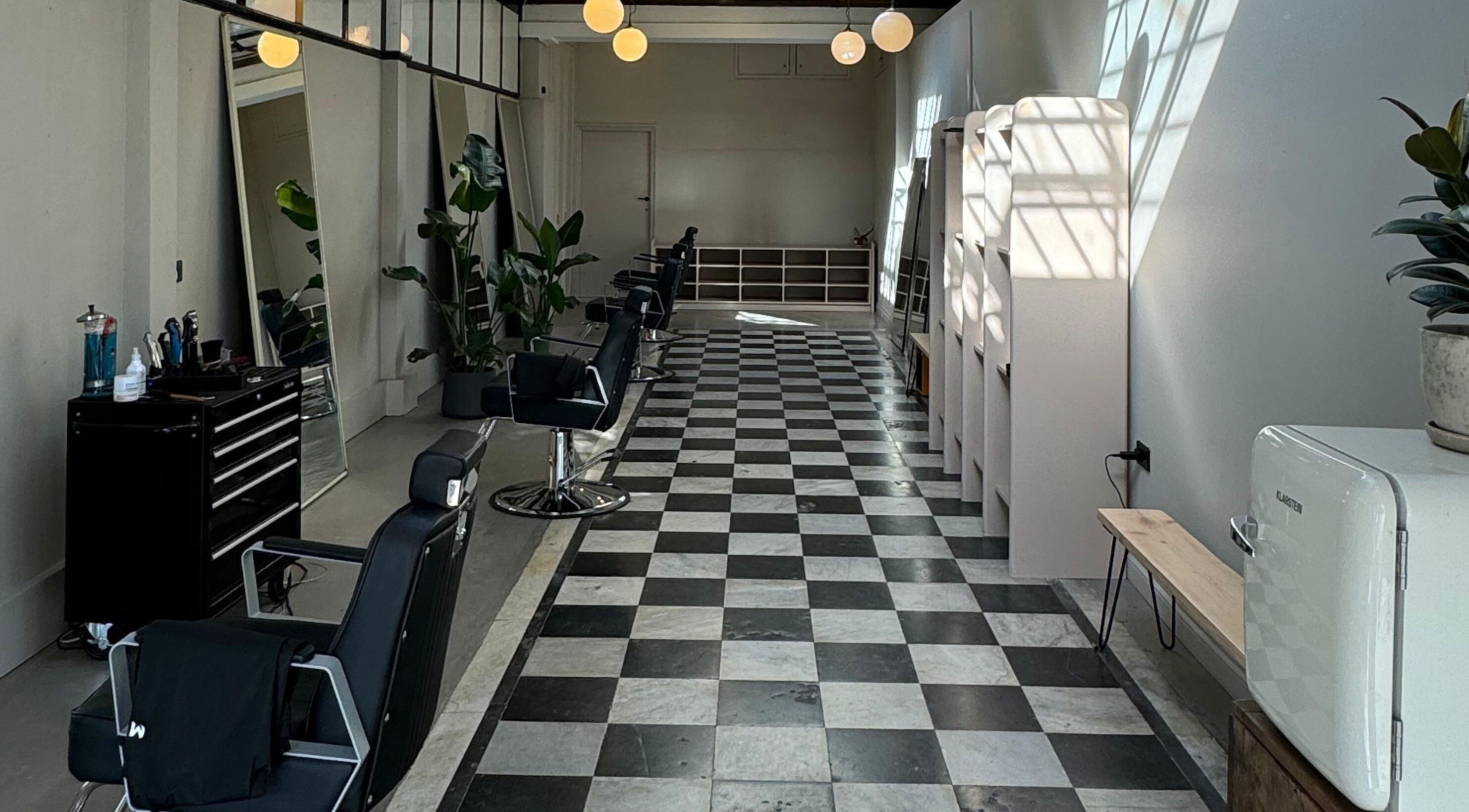 Interior of MOAI Barber Studio in London, England, GB, features sleek chairs and modern decor.