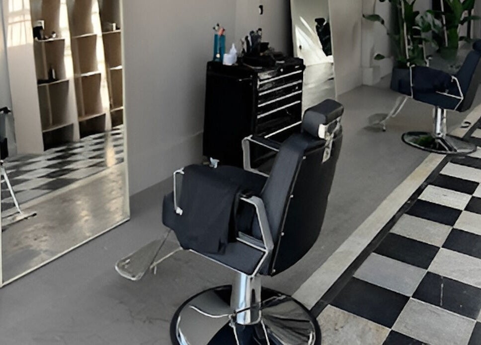 Modern barber chair and mirror at MOAI Barber Studio in London, England, GB.