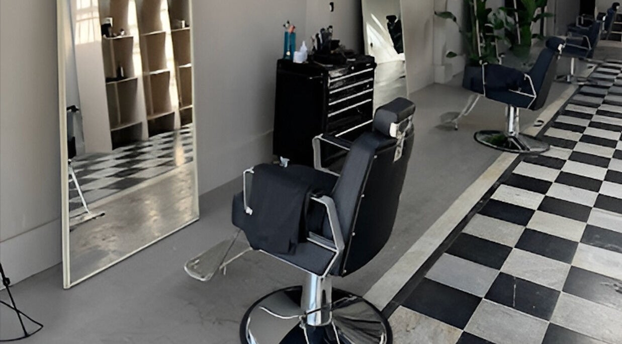 Modern barber chair and mirror at MOAI Barber Studio in London, England, GB.