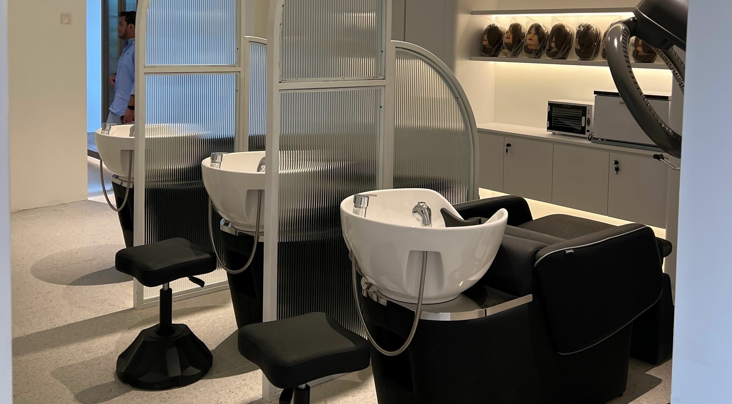 Modern salon washing stations at Hair Library in Petaling Jaya, Selangor, MY, featuring sleek design for a luxury experience.