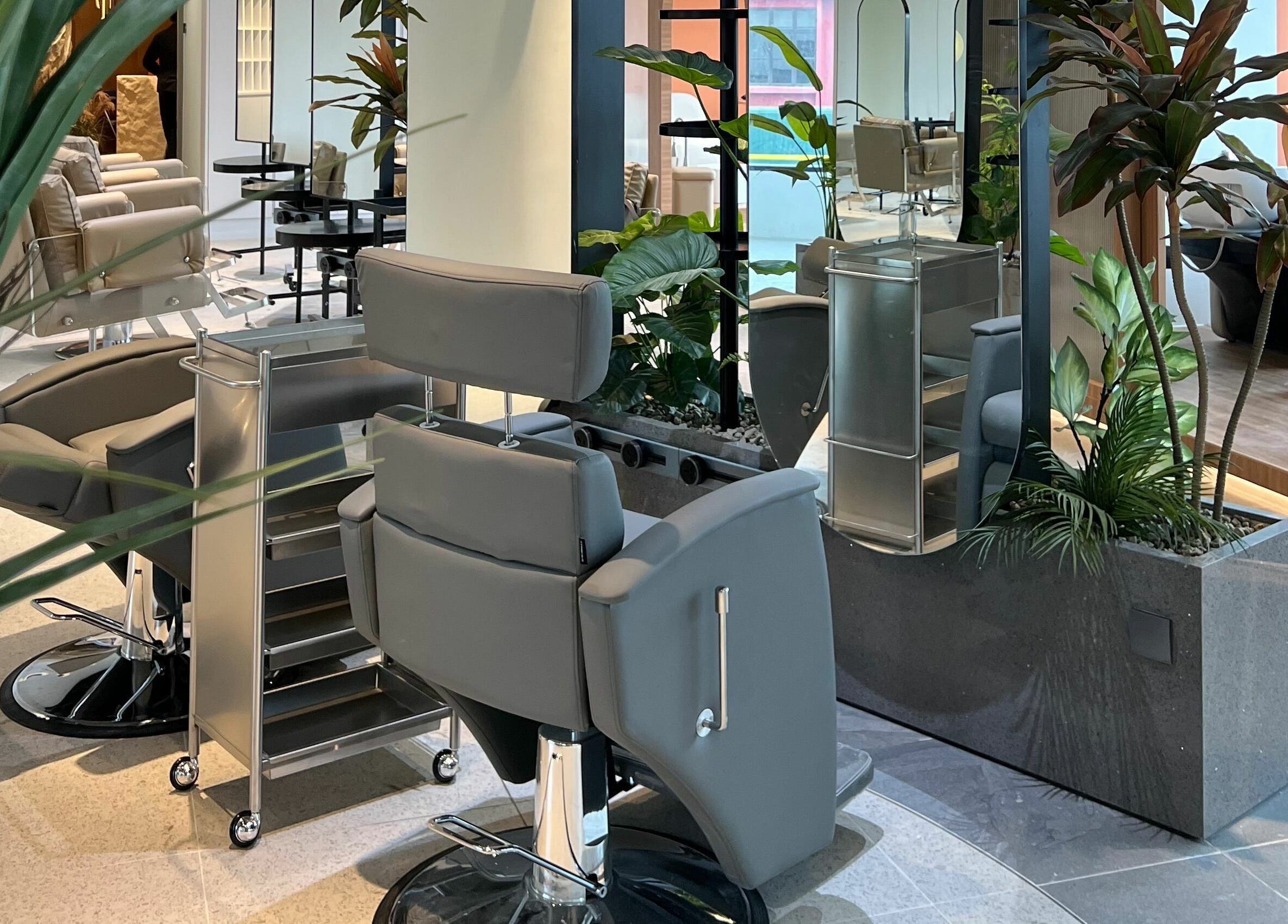 Modern styling chairs and lush plants at Hair Library, Petaling Jaya, Selangor, MY. Elegance and comfort combined.