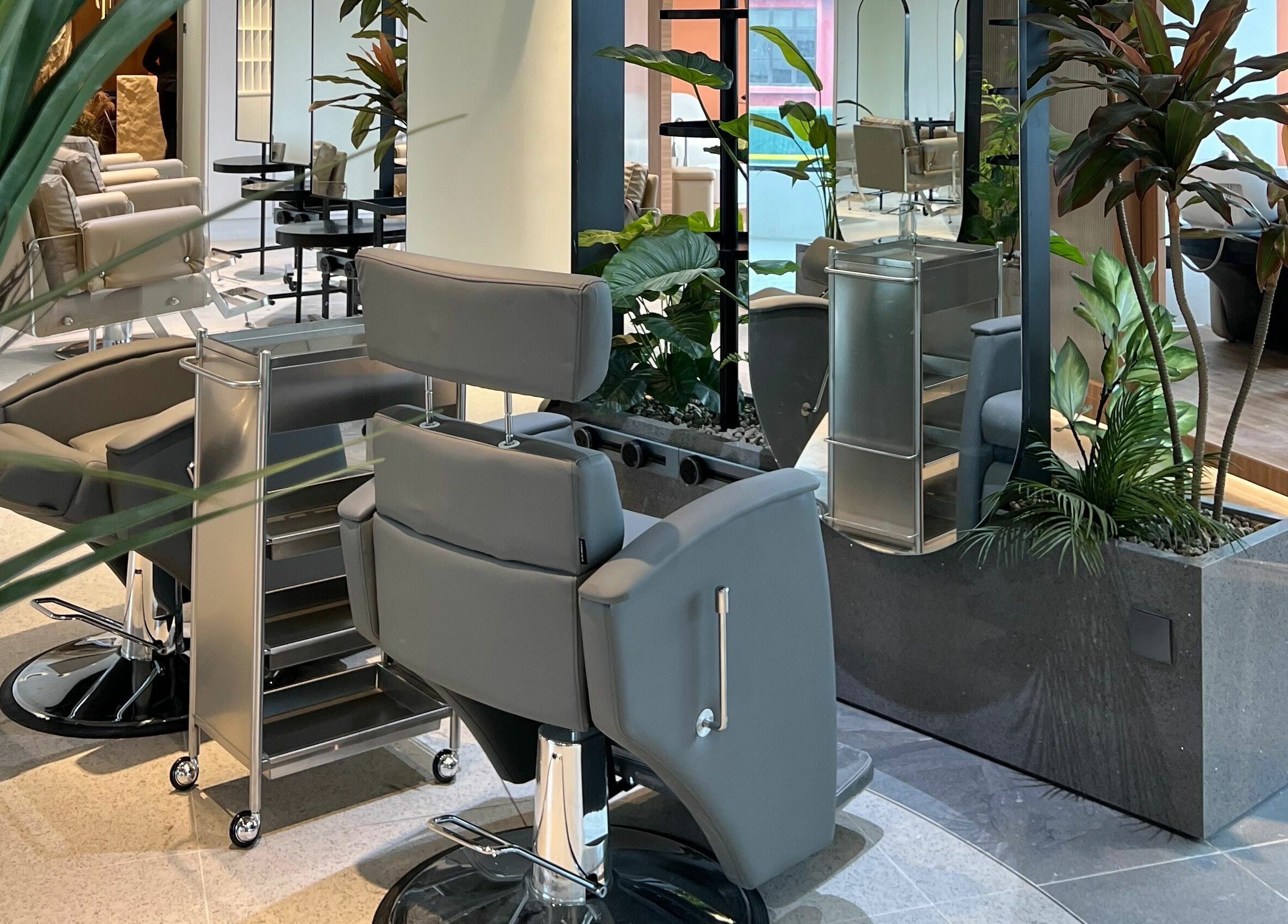 Modern styling chairs and lush plants at Hair Library, Petaling Jaya, Selangor, MY. Elegance and comfort combined.