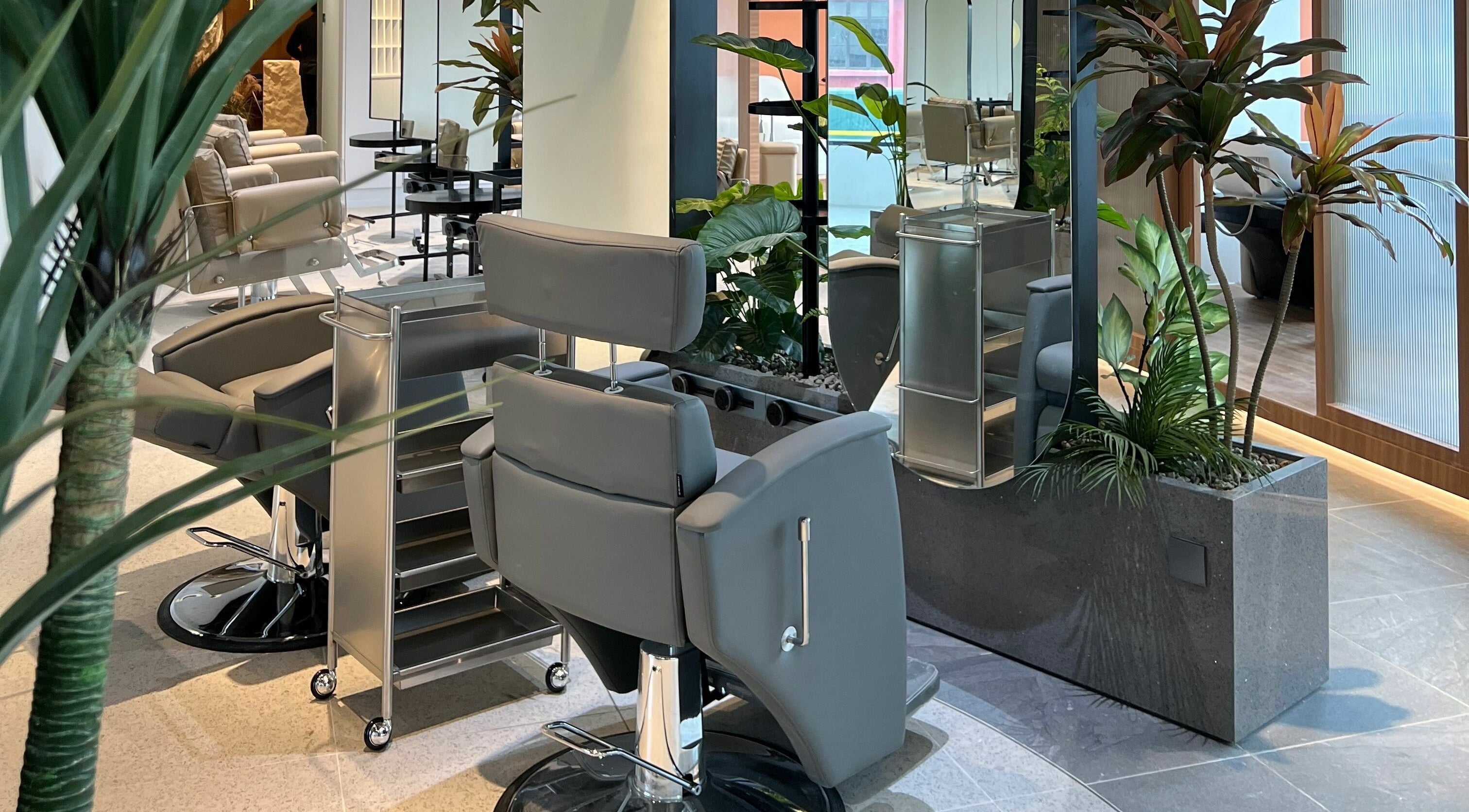 Modern styling chairs and lush plants at Hair Library, Petaling Jaya, Selangor, MY. Elegance and comfort combined.