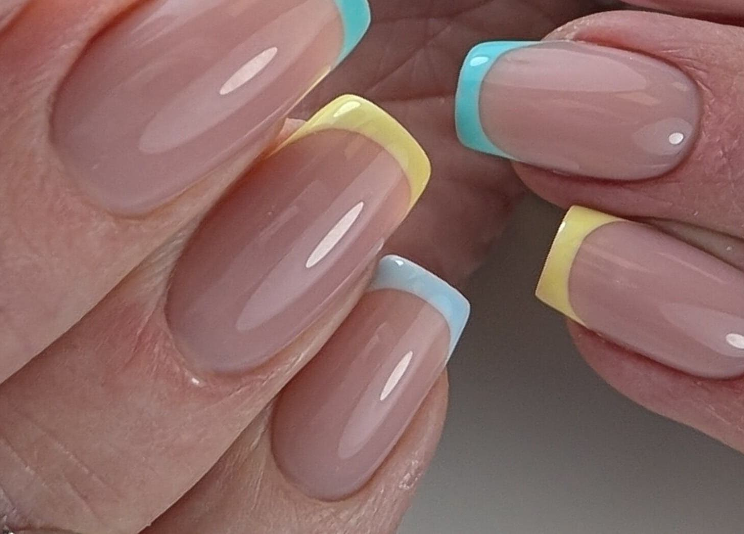 Colorful French manicure at Pure&Luxe Nails, Northampton, England, GB, showcasing elegant nail art.