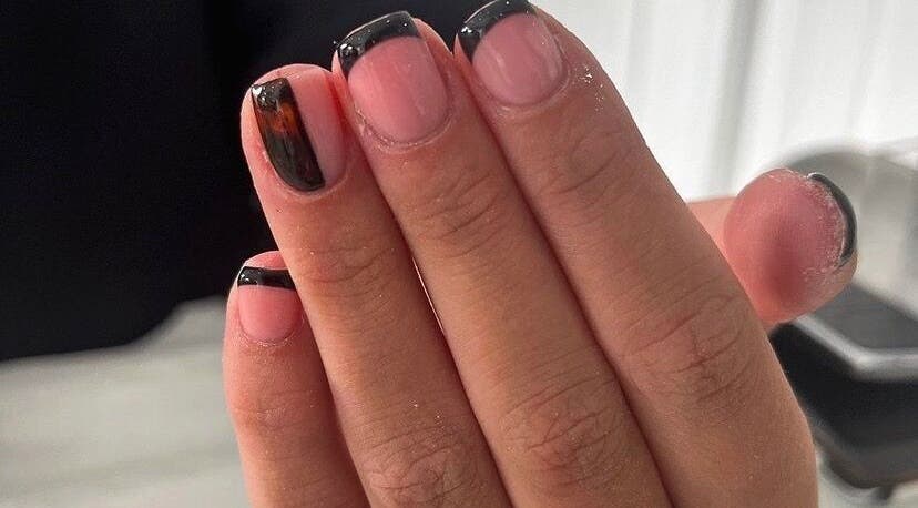 Elegant French manicure at Buffed, Kirkmuirhill, Scotland, GB, showcasing glossy black nail tips.