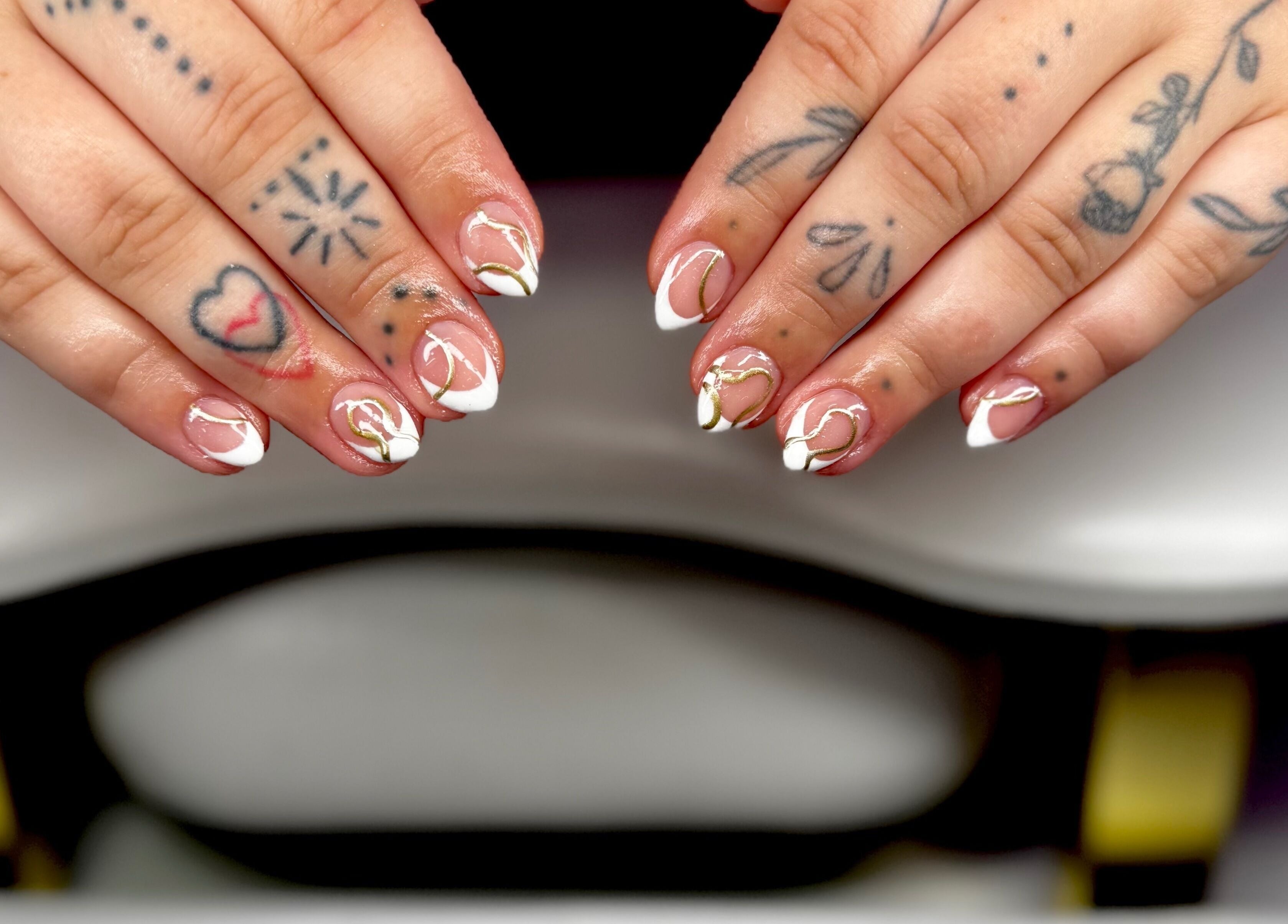Stylish nail art design at Bree Taylorr in Weymouth, England, GB. Intricate patterns and tattoos visible.