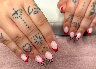 Creative red and pink nail art with tattoos at Bree Taylorr, Weymouth, England, GB.
