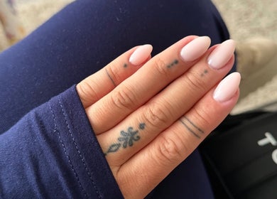 Close-up of manicured nails with tattoos at Bree Taylorr, Weymouth, England, GB.