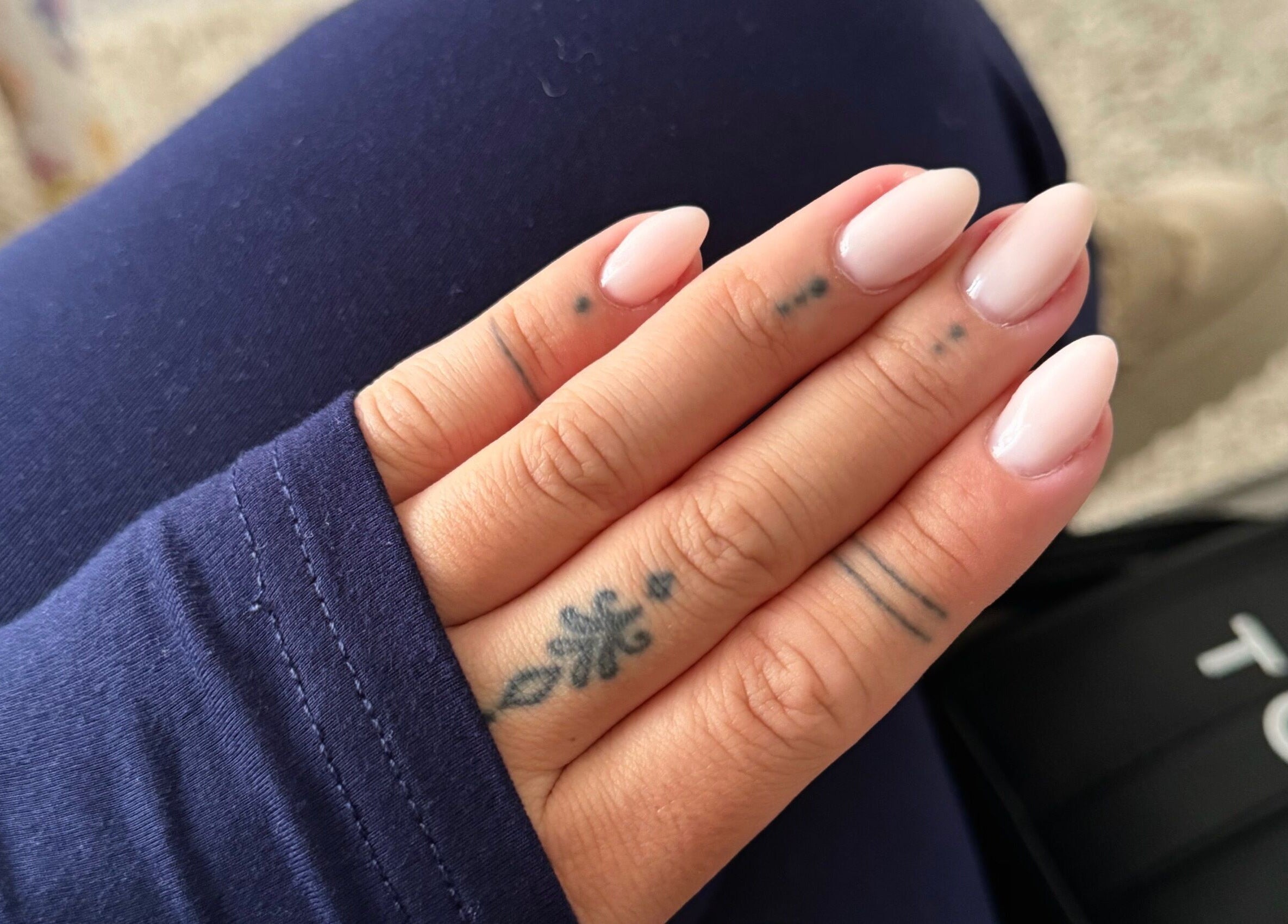 Close-up of manicured nails with tattoos at Bree Taylorr, Weymouth, England, GB.