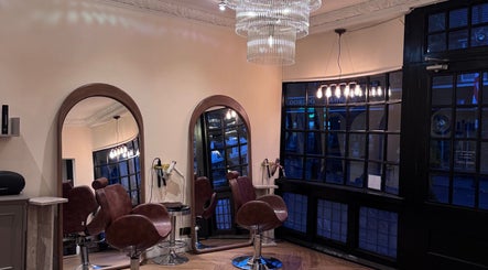 Elegant interior of FiftyEight Hair Design with mirrors and chairs in Gillingham, England, GB.