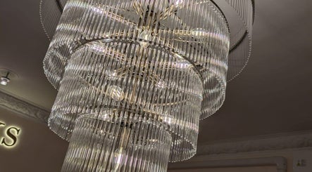 Luxurious chandelier at FiftyEight Hair Design, Gillingham, England, GB enhances the salon's ambiance.