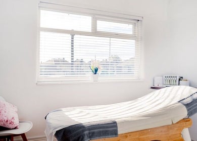 Relaxing treatment room at Opal Ink & Laser, Whiston, England, GB, bathed in natural light.