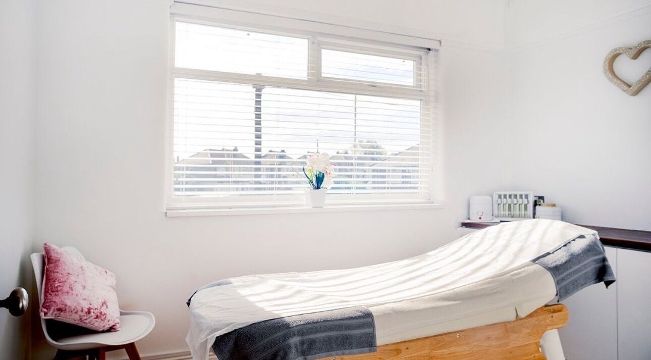 Relaxing treatment room at Opal Ink & Laser, Whiston, England, GB, bathed in natural light.