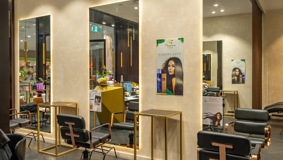 Stylish interior of Atelier Hair by C, West Ryde, New South Wales, AU showcasing chic salon chairs and mirrors.