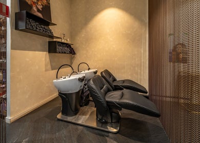 Relaxing shampoo area at Atelier Hair by C, West Ryde, New South Wales, AU with sleek black chairs.