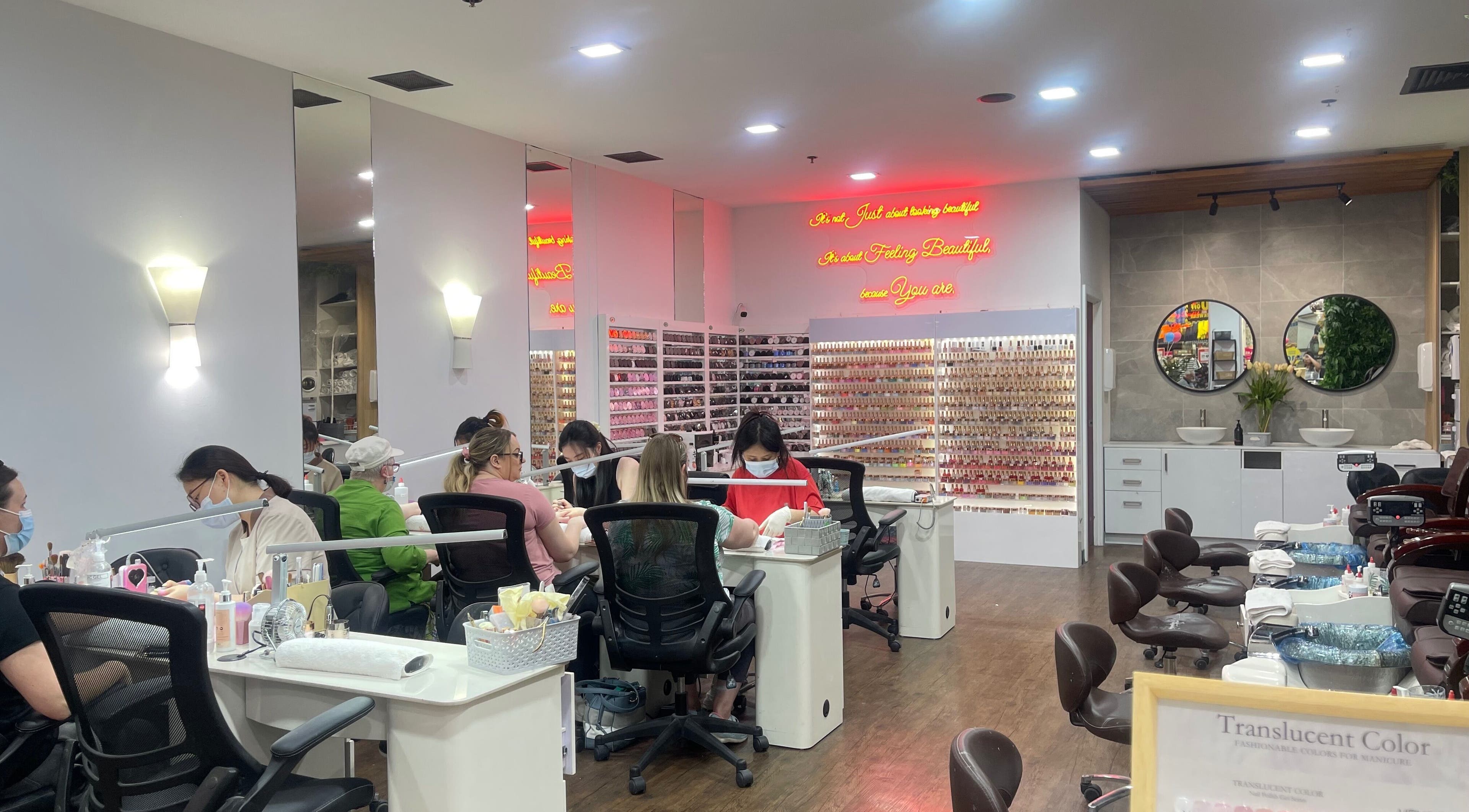 Interior of Castle Nail Bar in Edwardstown, South Australia, AU with clients and staff at work.