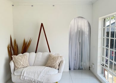 Cozy corner in Morganite Photography, Alberton, Gauteng, ZA with white sofa and natural decor.