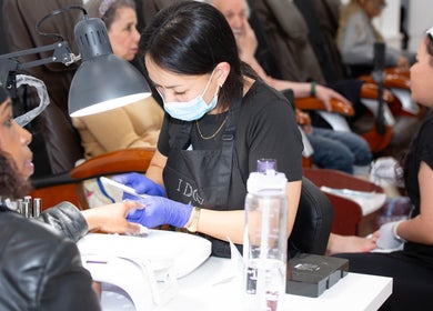 Technician providing manicure service at Act II Salon in Fairfax, Virginia, US.