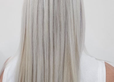 Straight platinum blonde hair styled at Gemma Fifty Eight Hair Design, Gillingham, England, GB.