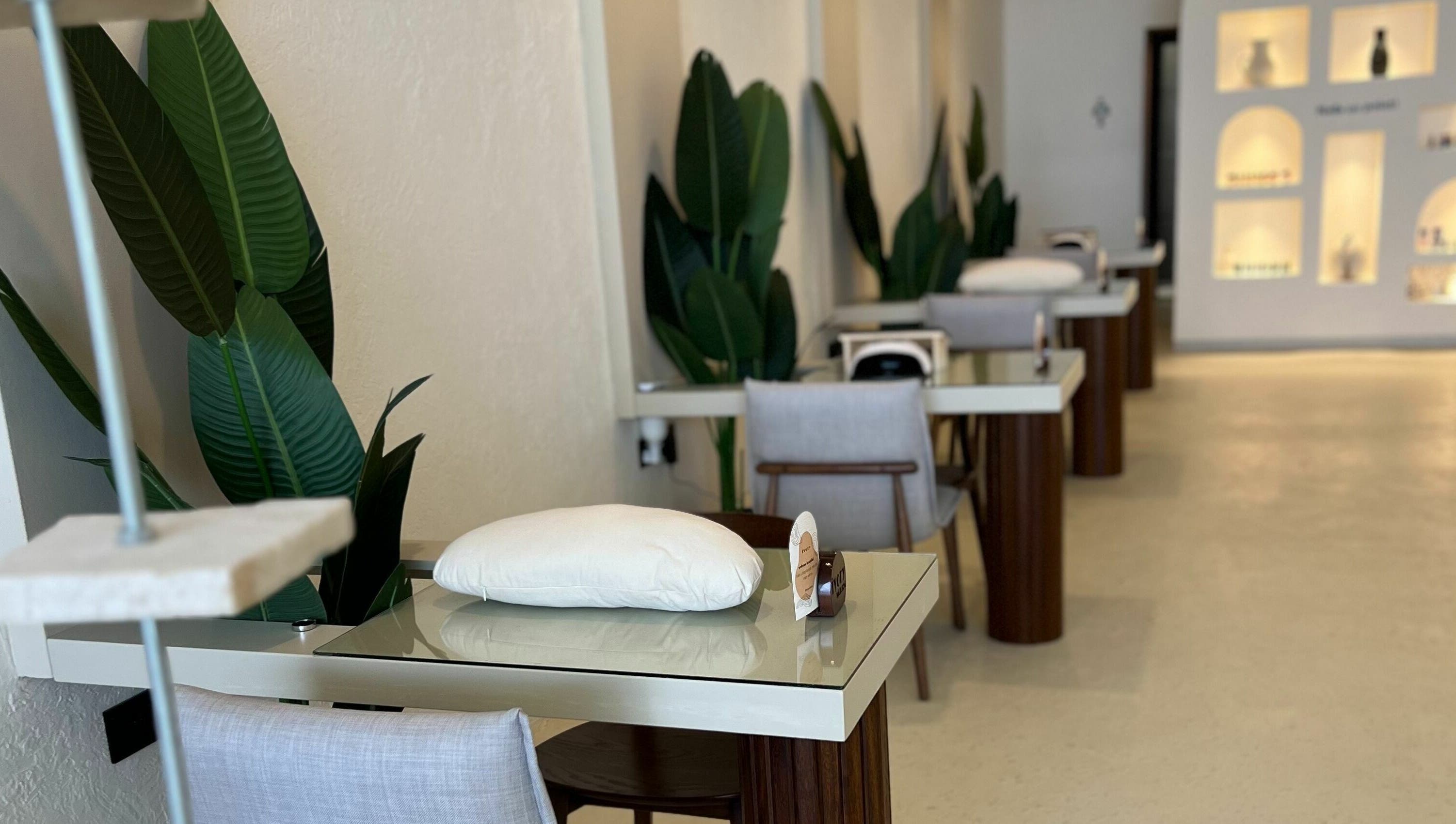 Sleek manicure stations at Ivory Nail Spa, Bisha, Aseer Province, SA, with plush seating and elegant decor.