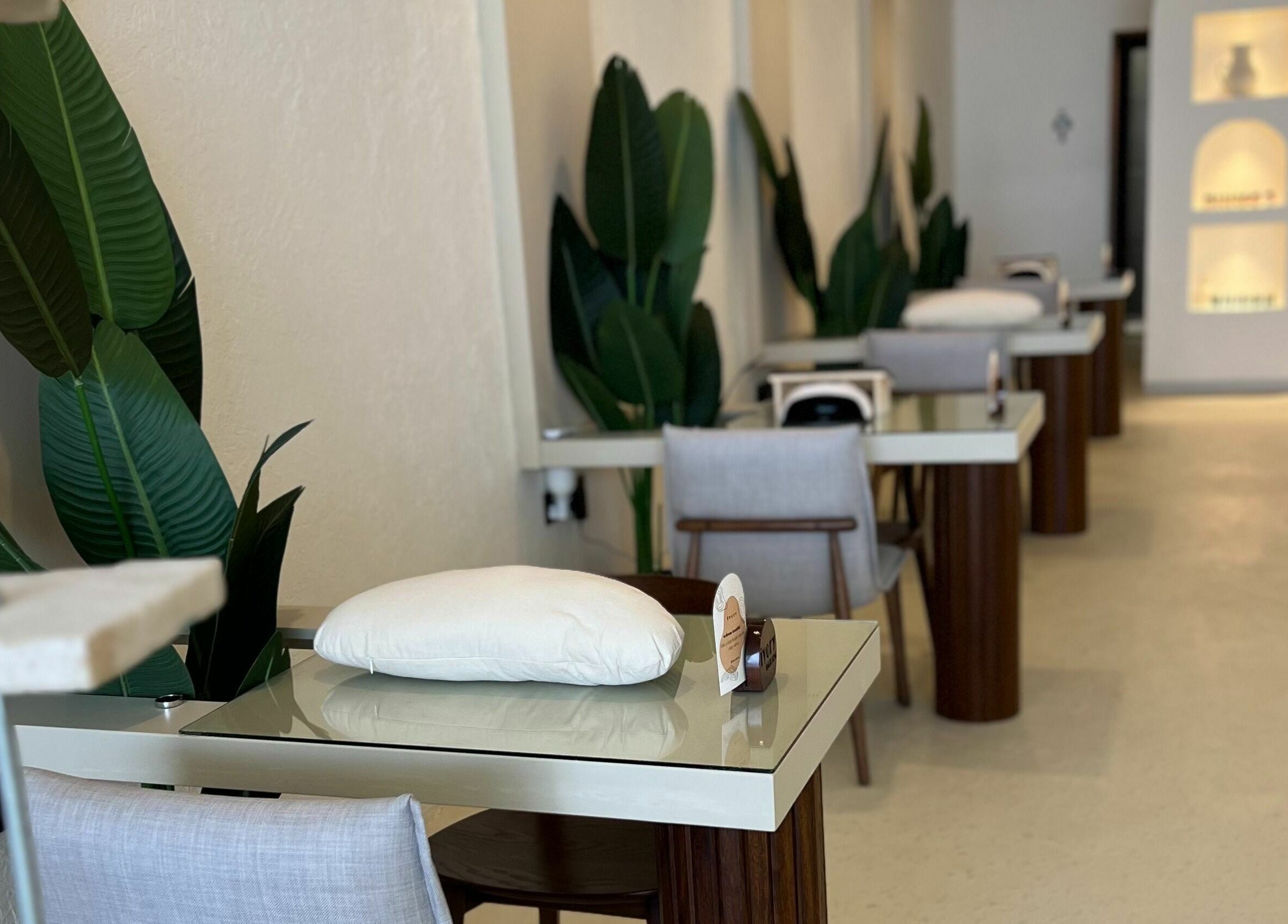 Sleek manicure stations at Ivory Nail Spa, Bisha, Aseer Province, SA, with plush seating and elegant decor.