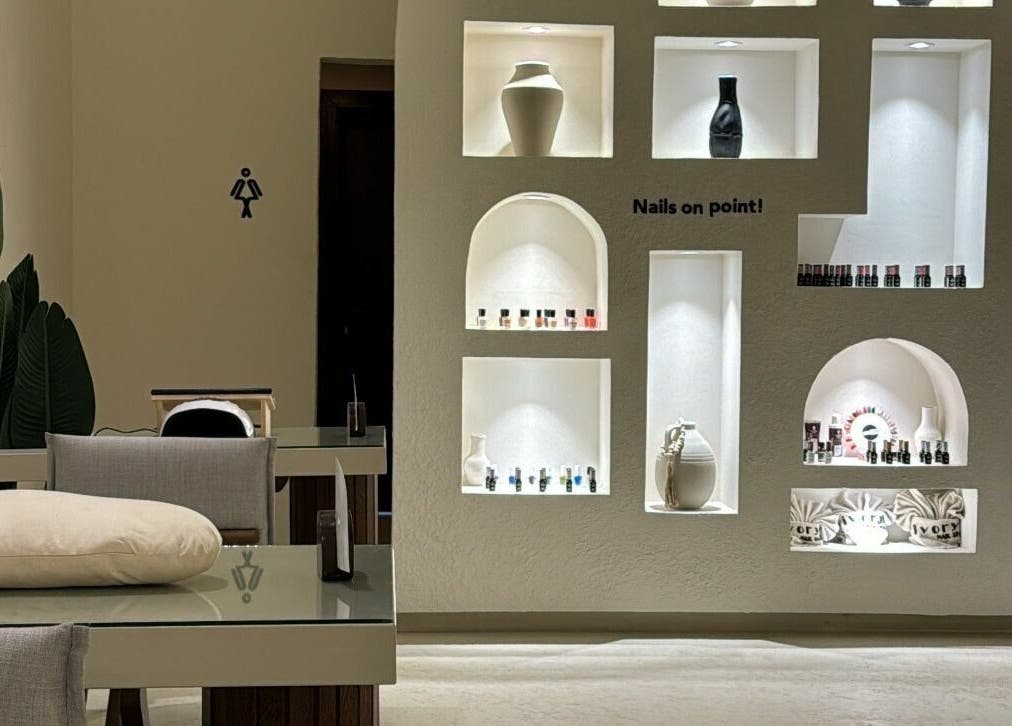Elegant interior of Ivory Nail Spa, Bisha, Aseer Province, SA, showcasing a stylish nail display wall.