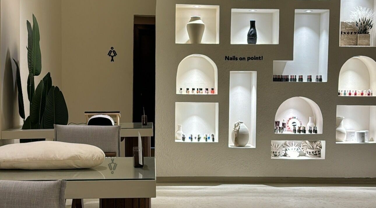 Elegant interior of Ivory Nail Spa, Bisha, Aseer Province, SA, showcasing a stylish nail display wall.