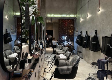 Modern salon interior at Nonstop Style 33 in New York, New York, US, featuring chic mirrors and plush chairs.