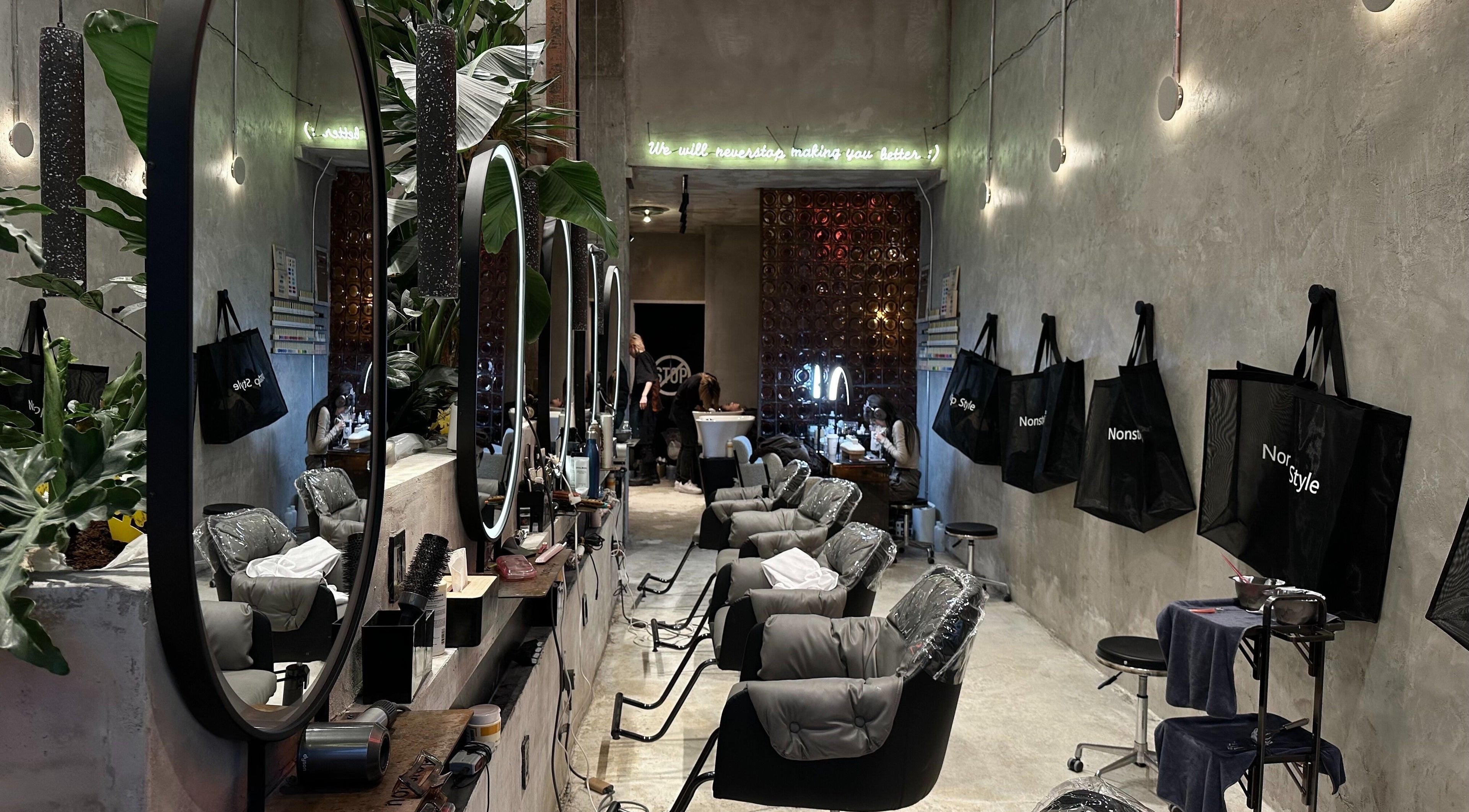 Modern salon interior at Nonstop Style 33 in New York, New York, US, featuring chic mirrors and plush chairs.