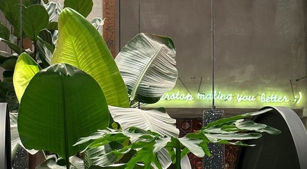 Greenery decor at Nonstop Style 33 in New York, New York, US with neon sign accentuates the ambiance.