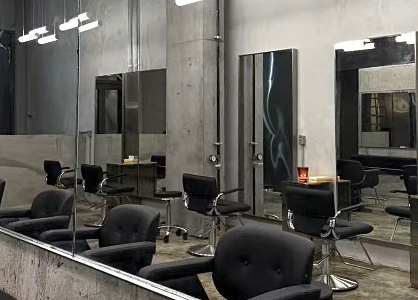 Modern salon chairs and mirrors at Nonstop Style LIC, New York, New York, US. Contemporary design and ambiance.