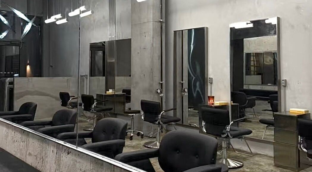 Modern salon chairs and mirrors at Nonstop Style LIC, New York, New York, US. Contemporary design and ambiance.