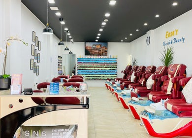 Interior of Ease's Nail and Beauty Caringbah, featuring red massage chairs and nail polish display, Caringbah, NSW, AU.