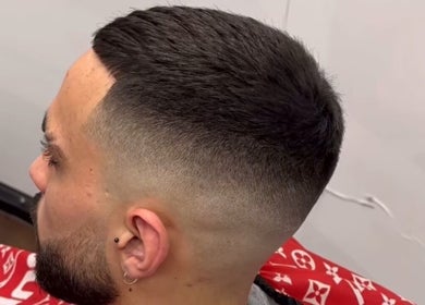 Crisp fade haircut at José J&DBarbers Studio, Manchester, England, GB. Professional grooming services offered.