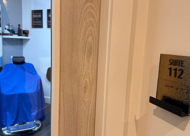 Suite 112 interior at José J&DBarbers Studio, Manchester, England, GB, showing a chair with a blue cover.