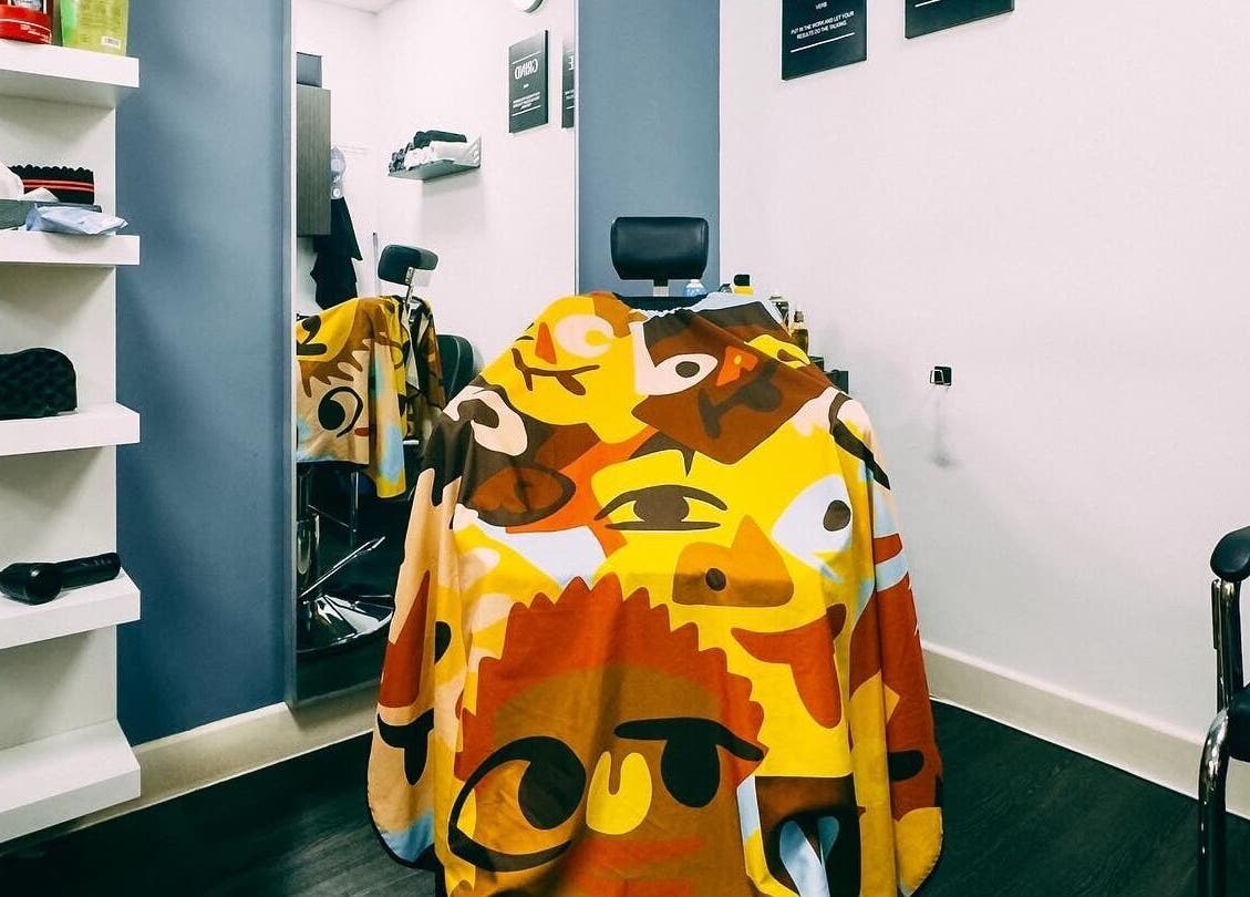 Colorful barber chair at José J&DBarbers Studio in Manchester, England, GB showcasing vibrant decor.