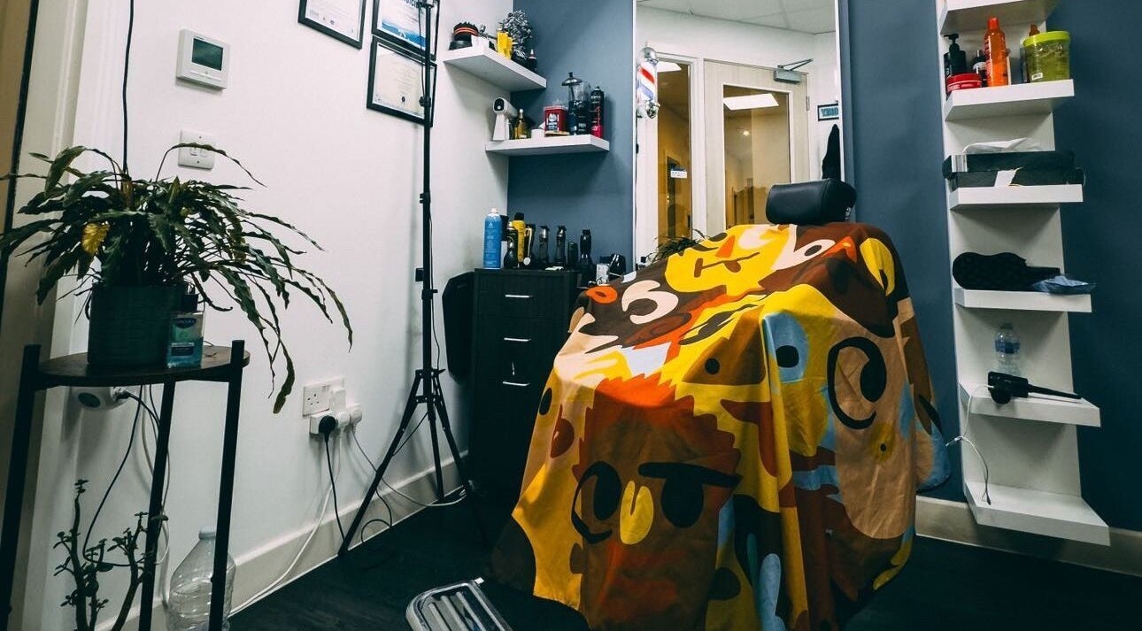 Vibrant barber chair at José J&DBarbers Studio, Manchester, England, GB. Stylish decor and grooming products visible.
