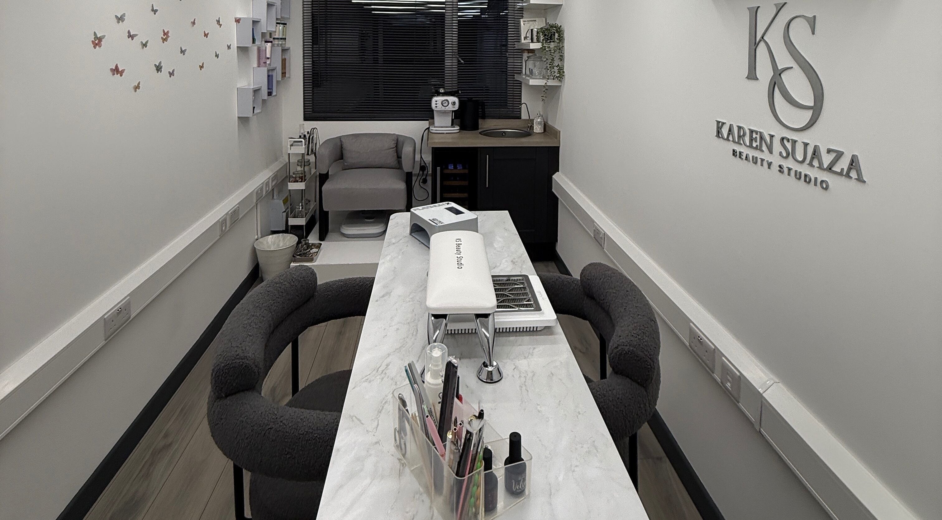 Modern interior of KS Karen Suaza Beauty Studio in Brookwood, England, GB, featuring elegant decor and seating.