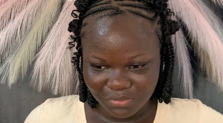 Intricate cornrow braids styled at Braided by Kie in Roseau, DM, showcasing professional hair artistry.