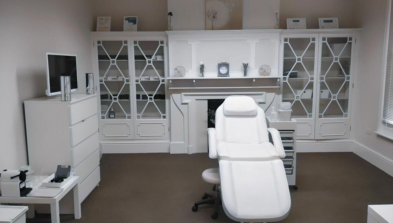 Elegant treatment room at Jnc Aesthetics, Eastbourne, England, GB, showcasing a white luxury spa chair.