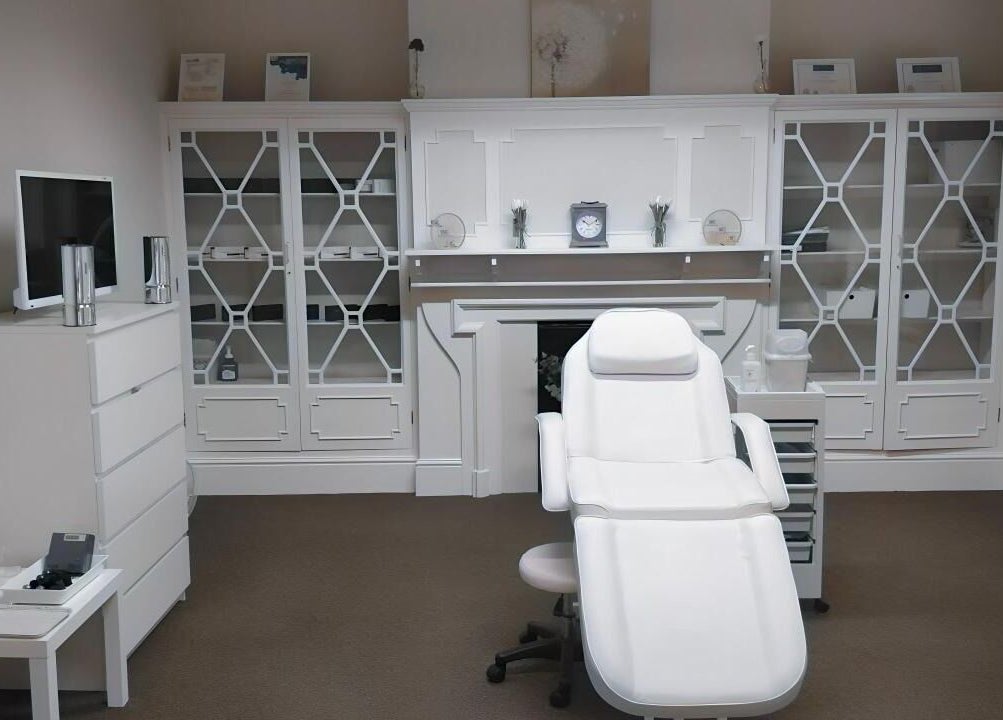 Elegant treatment room at Jnc Aesthetics, Eastbourne, England, GB, showcasing a white luxury spa chair.