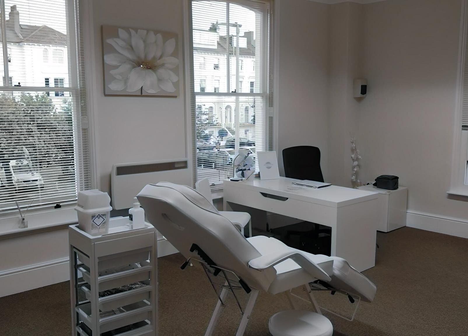 Sleek treatment room at Jnc Aesthetics in Eastbourne, England, GB, showcasing a comfortable chair and serene decor.